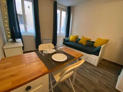 a living room with a table and a couch at Vieille ville in Nice