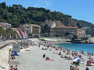 a group of people on a beach in the water at Vieille ville in Nice
