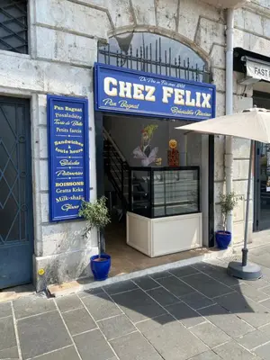 a restaurant with a sign on the side of a building at Vieille ville in Nice