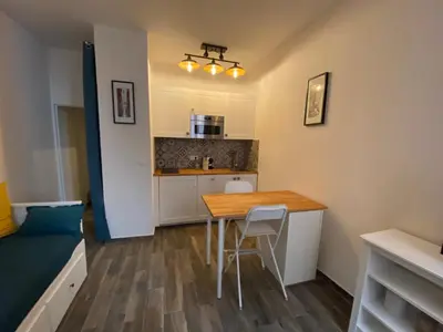 a small kitchen with a wooden table in a room at Vieille ville in Nice