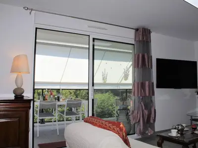 a bedroom with a bed and a large window at Appartement Neuf 3 Pièces avec Terrasse et Garage, Cagnes-sur-Mer - FR-1-252A-88 in Cagnes-sur-Mer