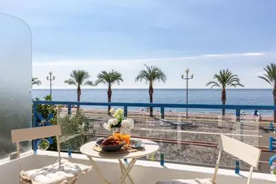 a table with a bowl of fruit on a balcony overlooking the ocean at PROMENADE SEA VIEW - Terrasse vue mer in Nice
