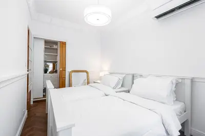 two beds in a room with white walls at PROMENADE SEA VIEW - Terrasse vue mer in Nice