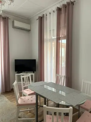 a dining room with a table and chairs and a television at Villa Niçoise.3P. 5 min de la plage in Nice