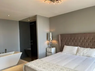a bedroom with a large bed and a bath tub at Villa LA ALEGRIA in Nice