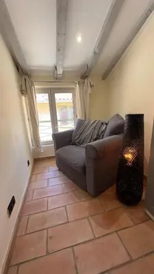 a living room with a couch sitting on a tile floor at Nice Vieille Ville Appartement neuf et cosy, deux chambres, 6 couchages in Nice