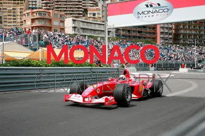a red racing car on a track in front of a crowd at Nice Vieille Ville Appartement neuf et cosy, deux chambres, 6 couchages in Nice