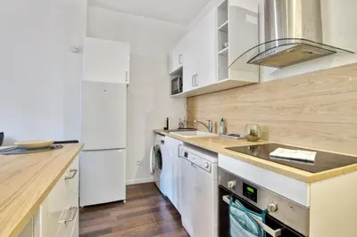 a kitchen with a sink and a dishwasher at Appartement Oscarmony - Welkeys in Nice