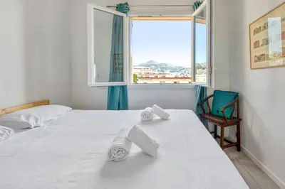 a bedroom with two beds and a window at Appartement Ayres - Welkeys in Nice