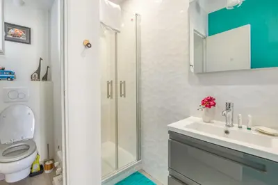 a bathroom with a shower and a toilet and a sink at Appartement Ayres - Welkeys in Nice