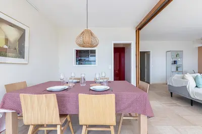 a dining room with a purple table and chairs at Amazing Sea View 2Bdr Swimming Pool Parking in Villefranche-sur-Mer