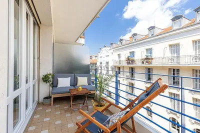 a balcony with chairs and a table on a building at Quiet 1 Bdr Downtown Terrace AC & Parking in Nice