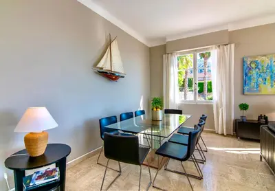 a dining room with a glass table and chairs at Villa Soleil d'Or in Villefranche-sur-Mer