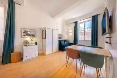 a kitchen with a table and a dining room at 06A3 - Lovely apartment in the heart of old Nice in Nice