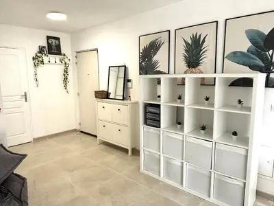 a living room with white shelves with plants on them at Appartement 6 pers Port de Nice, mer et Vieux-Nice à pied in Nice