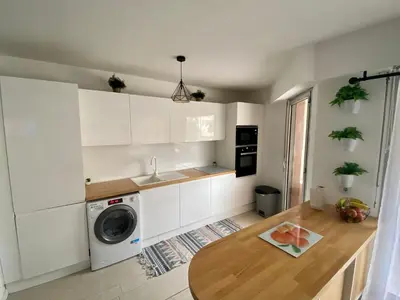 a kitchen with white cabinets and a washing machine at Appartement 6 pers Port de Nice, mer et Vieux-Nice à pied in Nice
