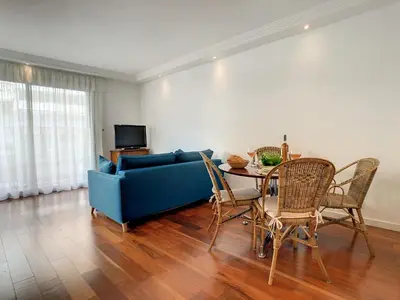 a living room with a blue couch and a table at BLUE RIVIERA TERRACE CENTRAL TRAIN STATION in Nice