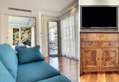 a living room with a blue couch and a television at BLUE RIVIERA TERRACE CENTRAL TRAIN STATION in Nice