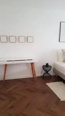 a white living room with a couch and a table at Nice Bel Appartement Vue Mer climatisé avec Grande Terrasse in Nice