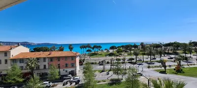 a view of a street in a city with the ocean at Nice Bel Appartement Vue Mer climatisé avec Grande Terrasse in Nice