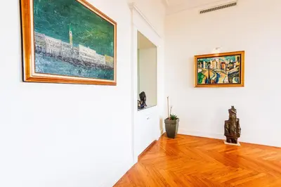 a room with a painting on the wall and a wooden floor at PALAIS ALBERT 1ER AP4292 By Riviera Holiday Homes in Nice