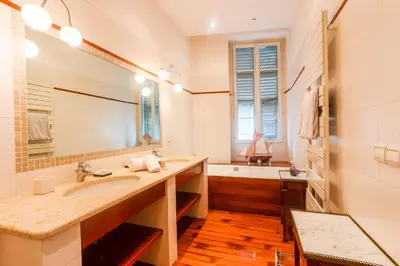 a bathroom with a sink and a tub and a mirror at PALAIS ALBERT 1ER AP4292 By Riviera Holiday Homes in Nice