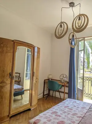 a bedroom with a bed and a mirror and a table at Amazing 2-bedroom apartment in Nice near the beach in Nice