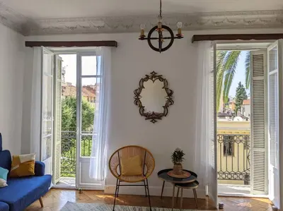 a living room with a blue couch and a table at Amazing 2-bedroom apartment in Nice near the beach in Nice