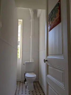 a bathroom with a white toilet and a door at Amazing 2-bedroom apartment in Nice near the beach in Nice