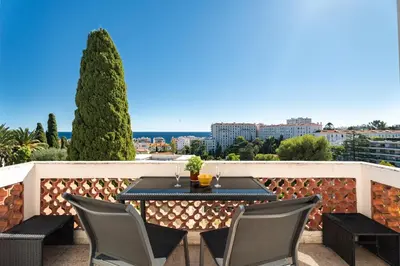 a table and chairs on a balcony with a view at Nice Renting - CAMBRAI - Luxurious Sea View Terrasse - King Bed - Parking - AC - fully equipped in Nice
