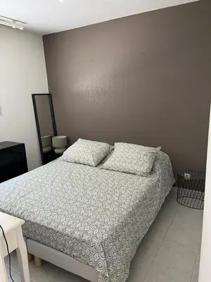 a bedroom with a bed with two pillows on it at Ninon in Nice