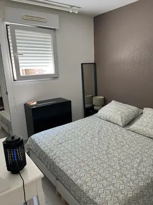 a bedroom with a bed and a window at Ninon in Nice