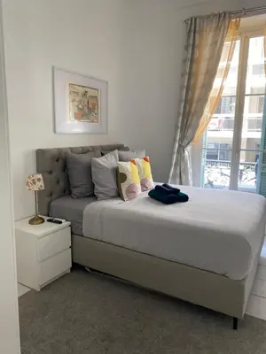 a bedroom with a bed and a window at The Grand Riviera Apartments Nice - Top Choice in Nice in Nice