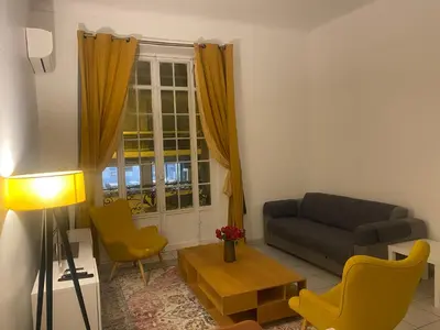 a living room with a couch and chairs and a window at The Grand Riviera Apartments Nice - Top Choice in Nice in Nice