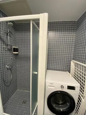 a bathroom with a washing machine in a shower at The Grand Riviera Apartments Nice - Top Choice in Nice in Nice