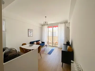 a living room with a couch and a table at Mediterranee - un trois pièces à deux pas de la plage in Nice