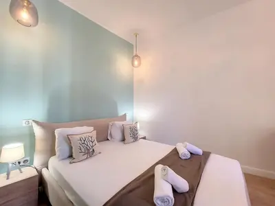 a bedroom with a bed with two slippers on it at Nestor&Jeeves - LE PIERLAS - Place Garibaldi - Very close Old Town in Nice