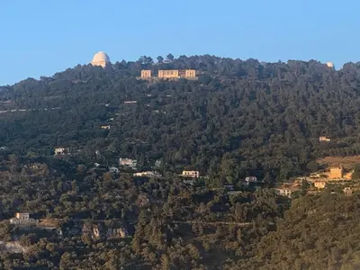 a building on top of a hill with trees at Appartement 02 Vue Panoramique -WIFI- Parking privé -NICE in Nice