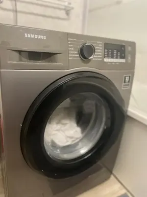 a washing machine with its door open in a kitchen at I Love you Berry Berry Much! in Nice