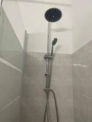 a shower with a shower head in a bathroom at I Love you Berry Berry Much! in Nice