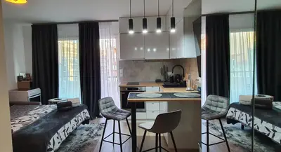 a kitchen and living room with a bed and a table at Lovely 1 bedroom vacation home with free parking. in Nice