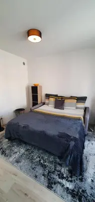 a bedroom with a bed in a white room at Lovely 1 bedroom vacation home with free parking. in Nice