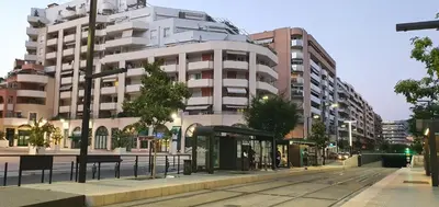 a large white building on a city street at Lovely 1 bedroom vacation home with free parking. in Nice