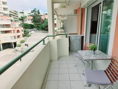 a balcony with a table and chairs on a building at Lovely 1 bedroom vacation home with free parking. in Nice