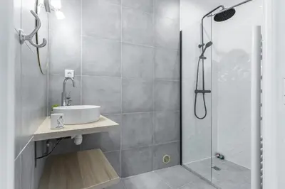 a bathroom with a sink and a shower at LE 323 PROM - BEACHFRONT - PARKING - NEAR TRAM &SUPERMARKET - AC - washing machine in Nice