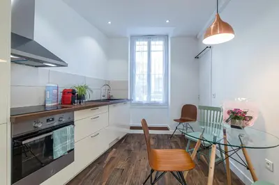 a kitchen with a glass table and a dining room at LE 323 PROM - BEACHFRONT - PARKING - NEAR TRAM &SUPERMARKET - AC - washing machine in Nice