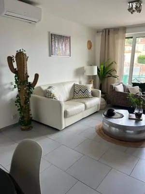 a living room with a couch and a table at Beau 2P, très équipé, localisation parfaite/AC in Villefranche-sur-Mer