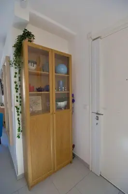 a kitchen with a wooden cabinet in a room at Beau 2P, très équipé, localisation parfaite/AC in Villefranche-sur-Mer