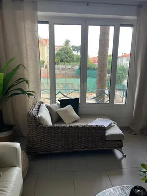 a couch in a living room with a large window at Beau 2P, très équipé, localisation parfaite/AC in Villefranche-sur-Mer