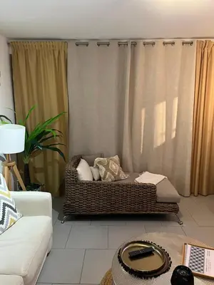 a wicker couch in a living room with curtains at Beau 2P, très équipé, localisation parfaite/AC in Villefranche-sur-Mer